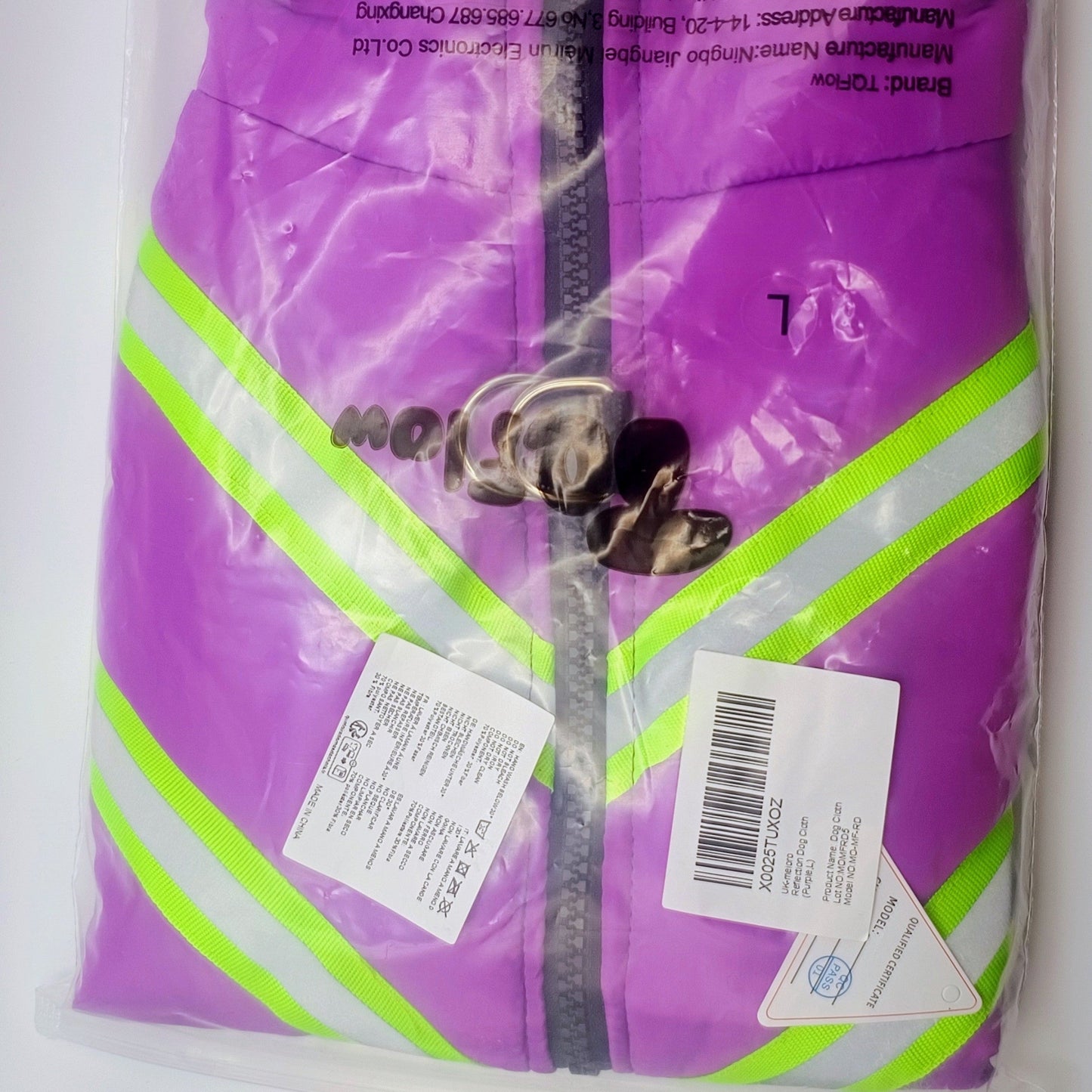 Purple bag with green stripes and a label on a white background