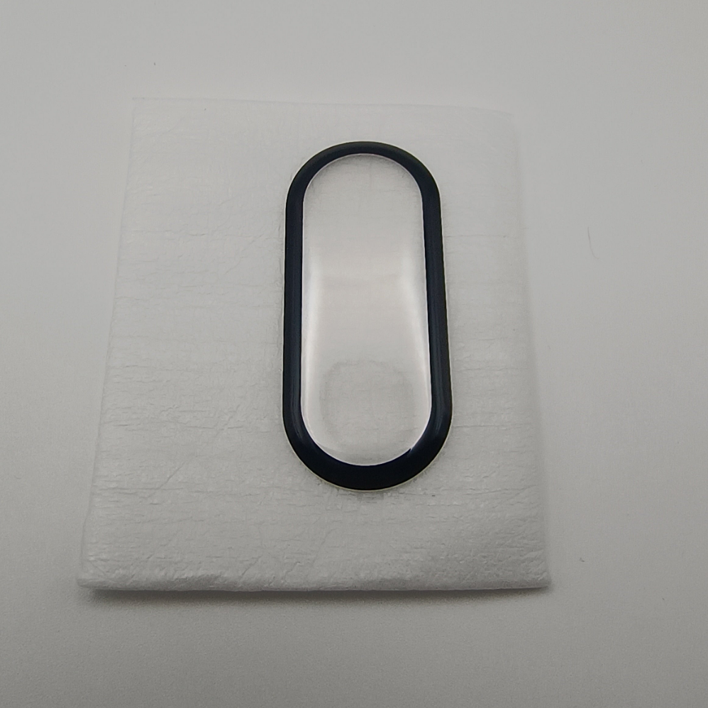 Black oval object on a textured white surface