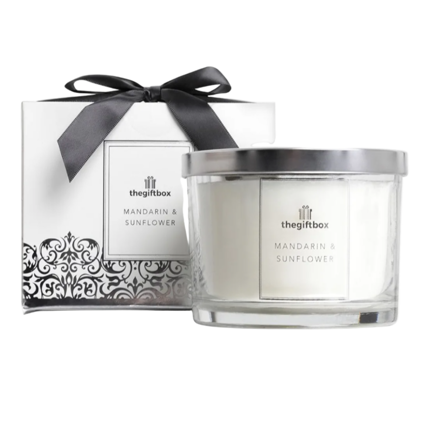 Candle with decorative box featuring 'the gift box' branding on a white background