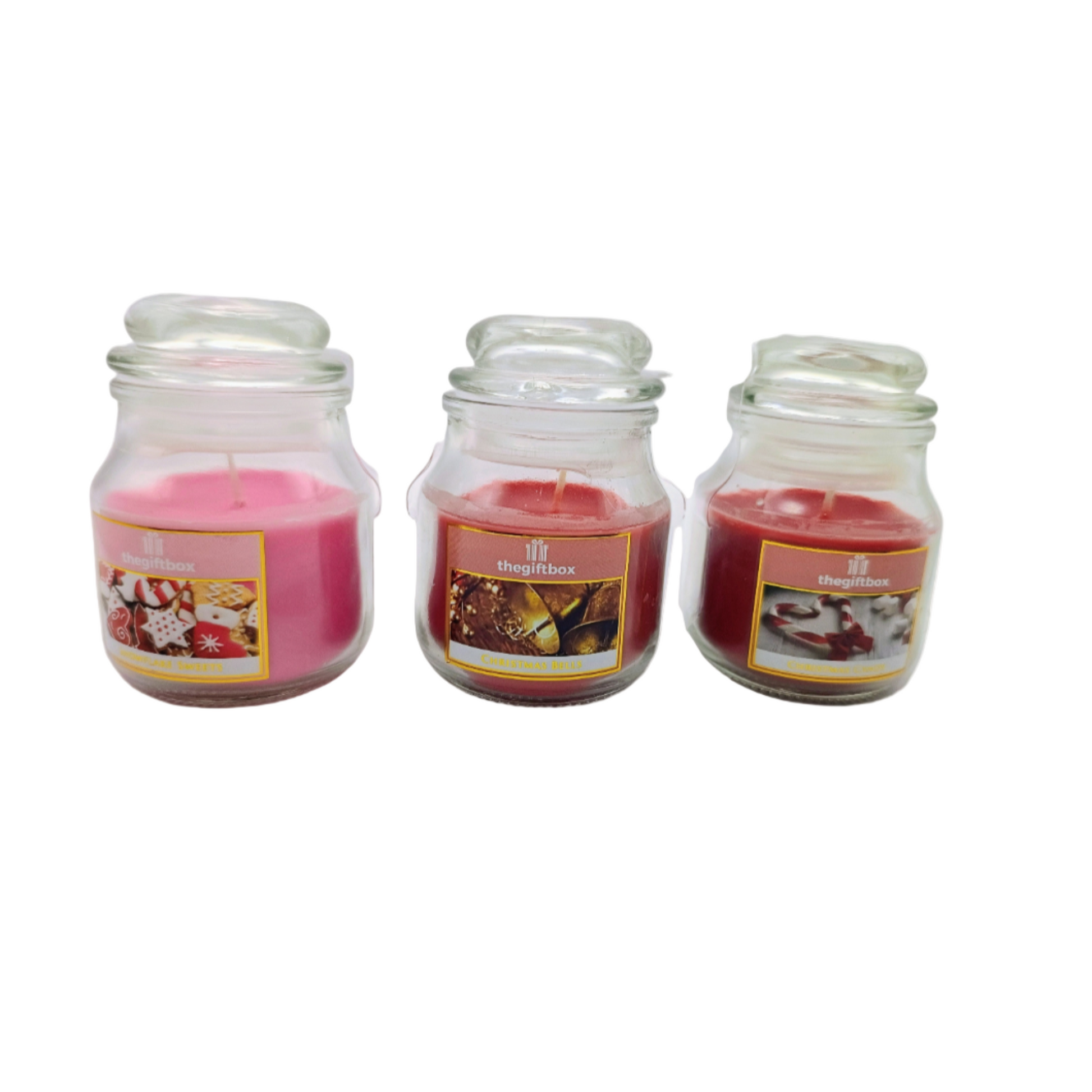 Three glass jars with candles inside on a white background