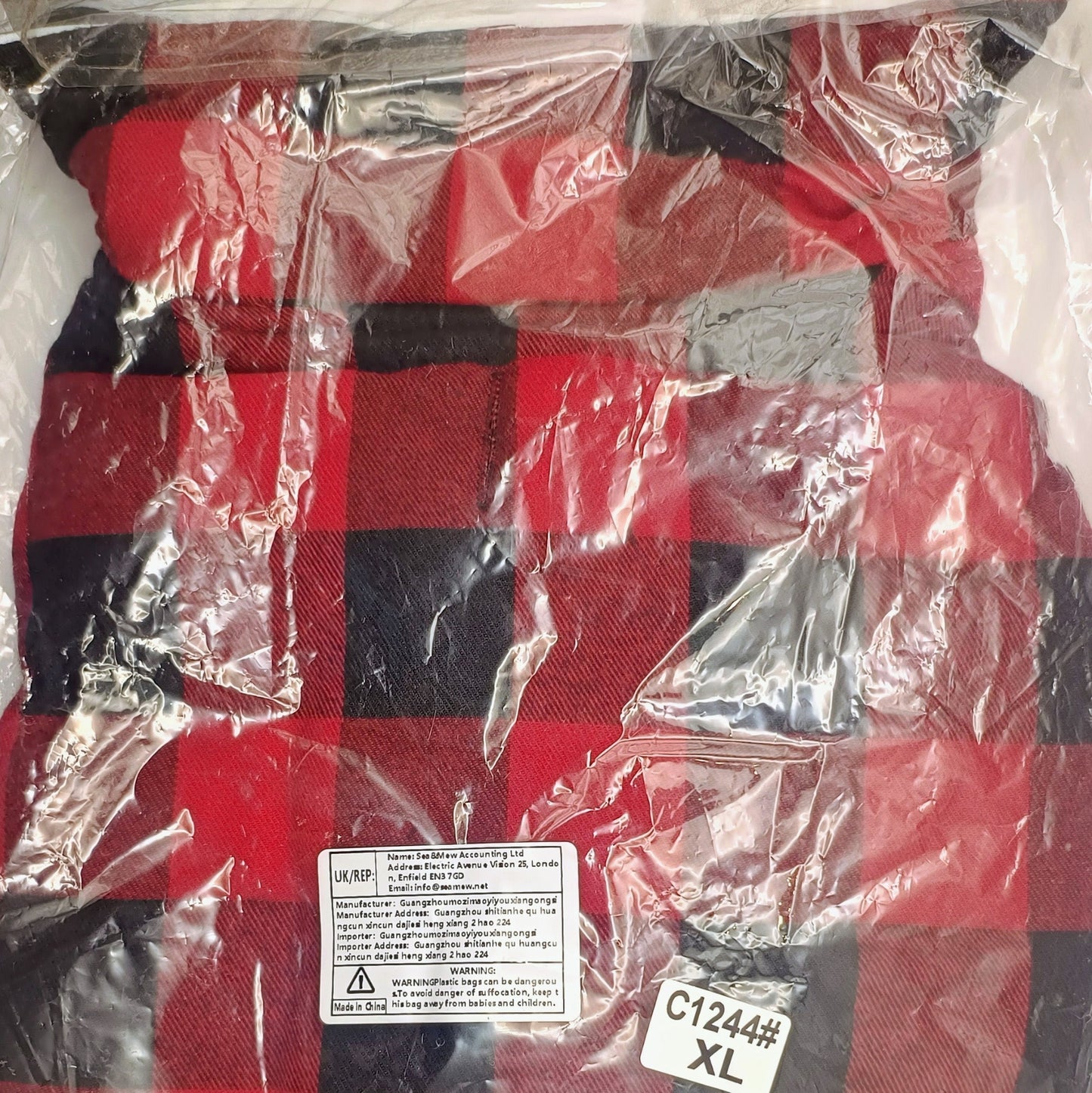 Red and black checkered fabric with a label on a clear background