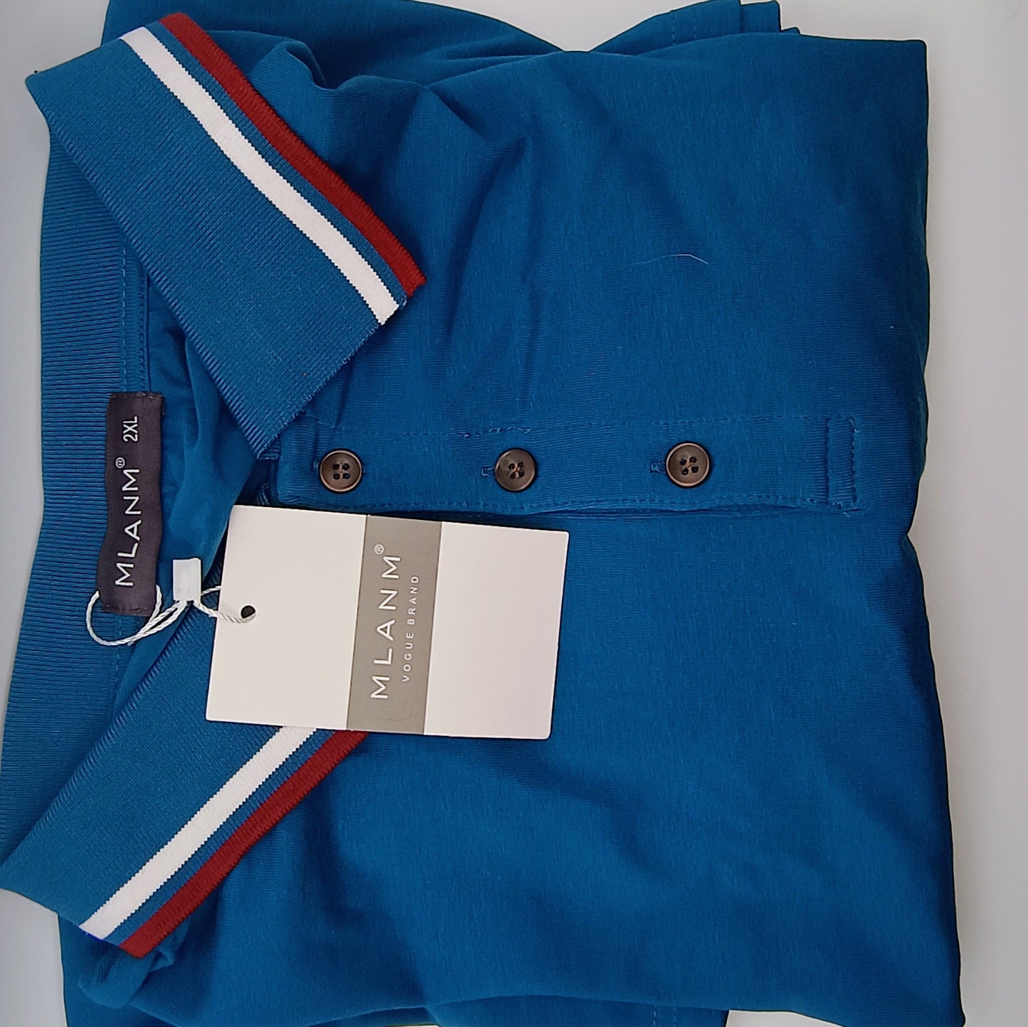 Folded blue shirt with a Milan label on a gray background