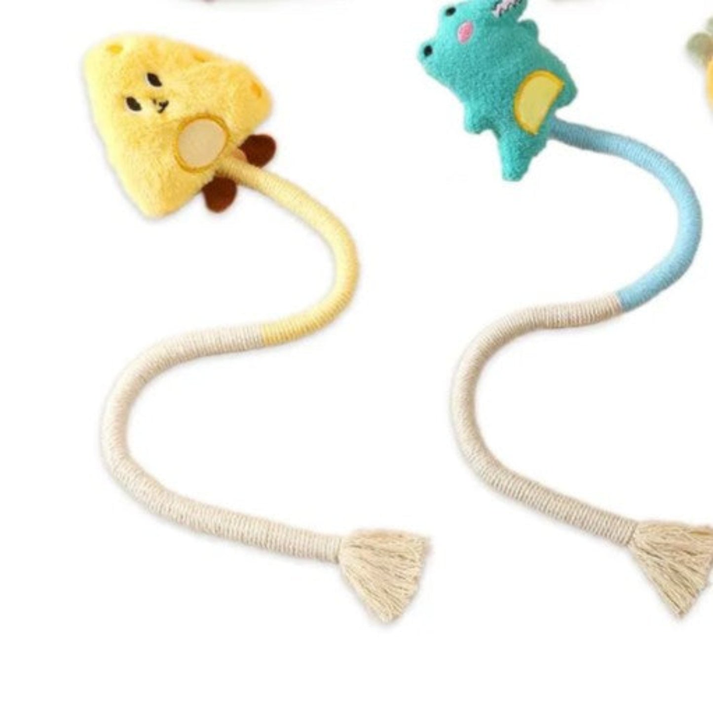 Two plush toys on a white background, one resembling a yellow bear and the other a blue creature.