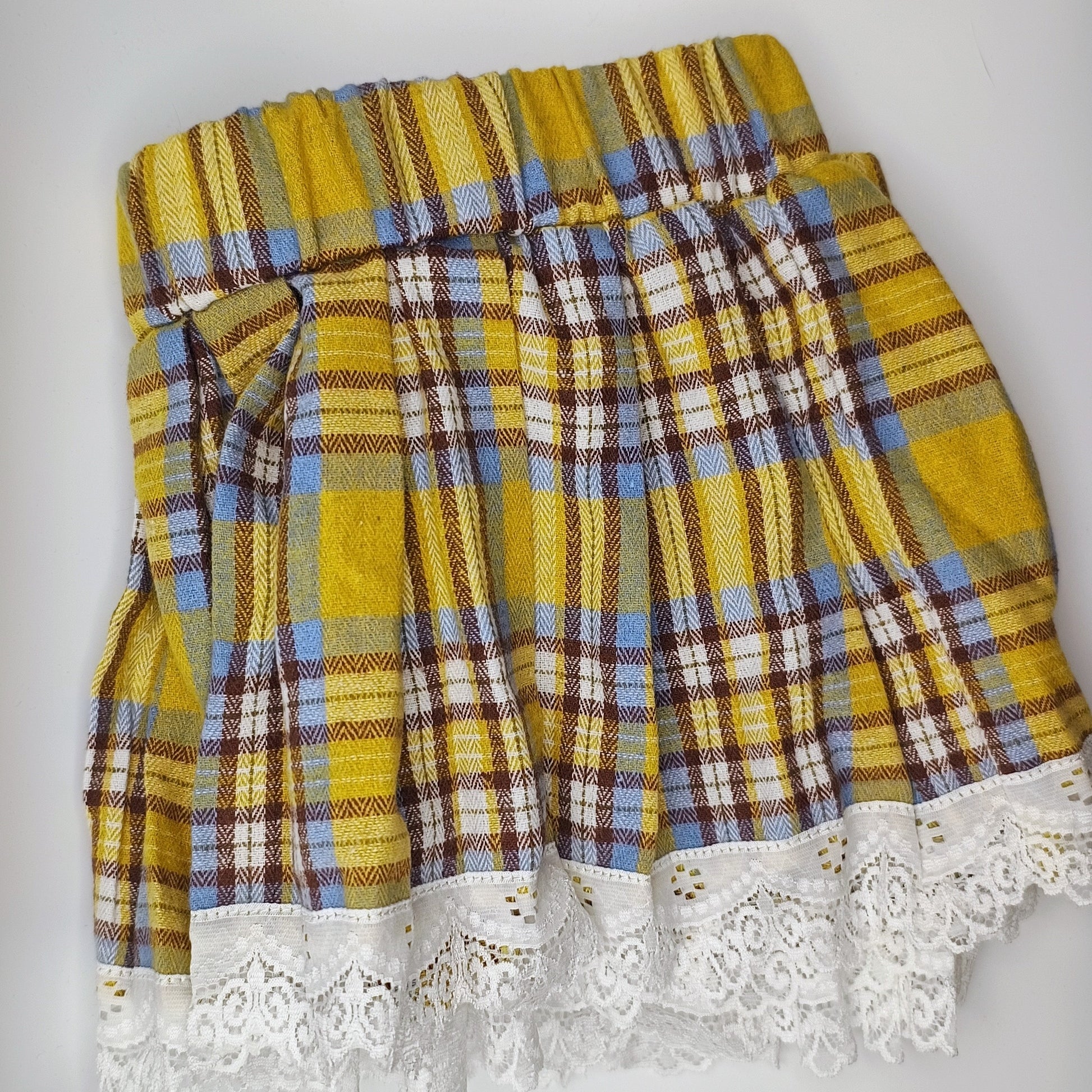 Plaid skirt with lace trim on a white background