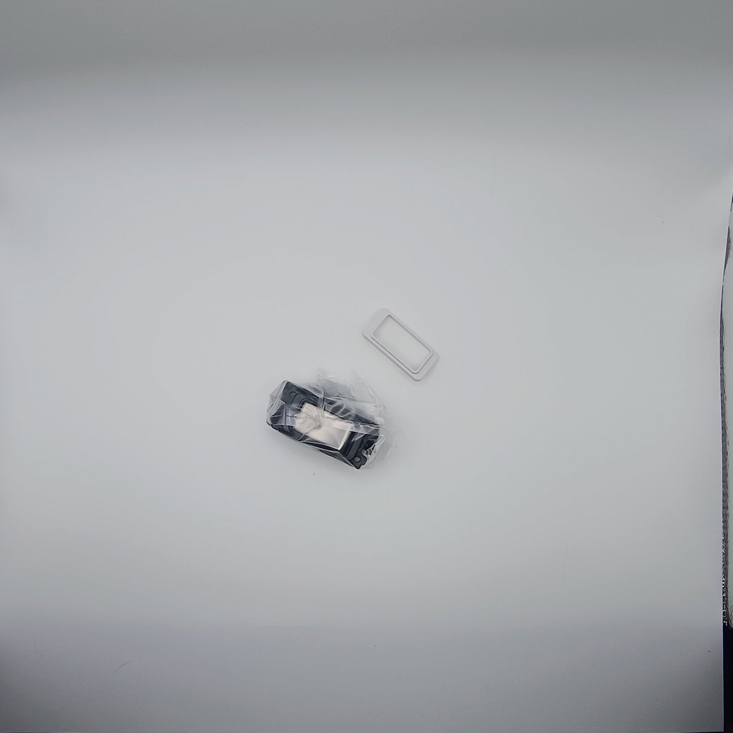 Two small rectangular objects on a light gray background