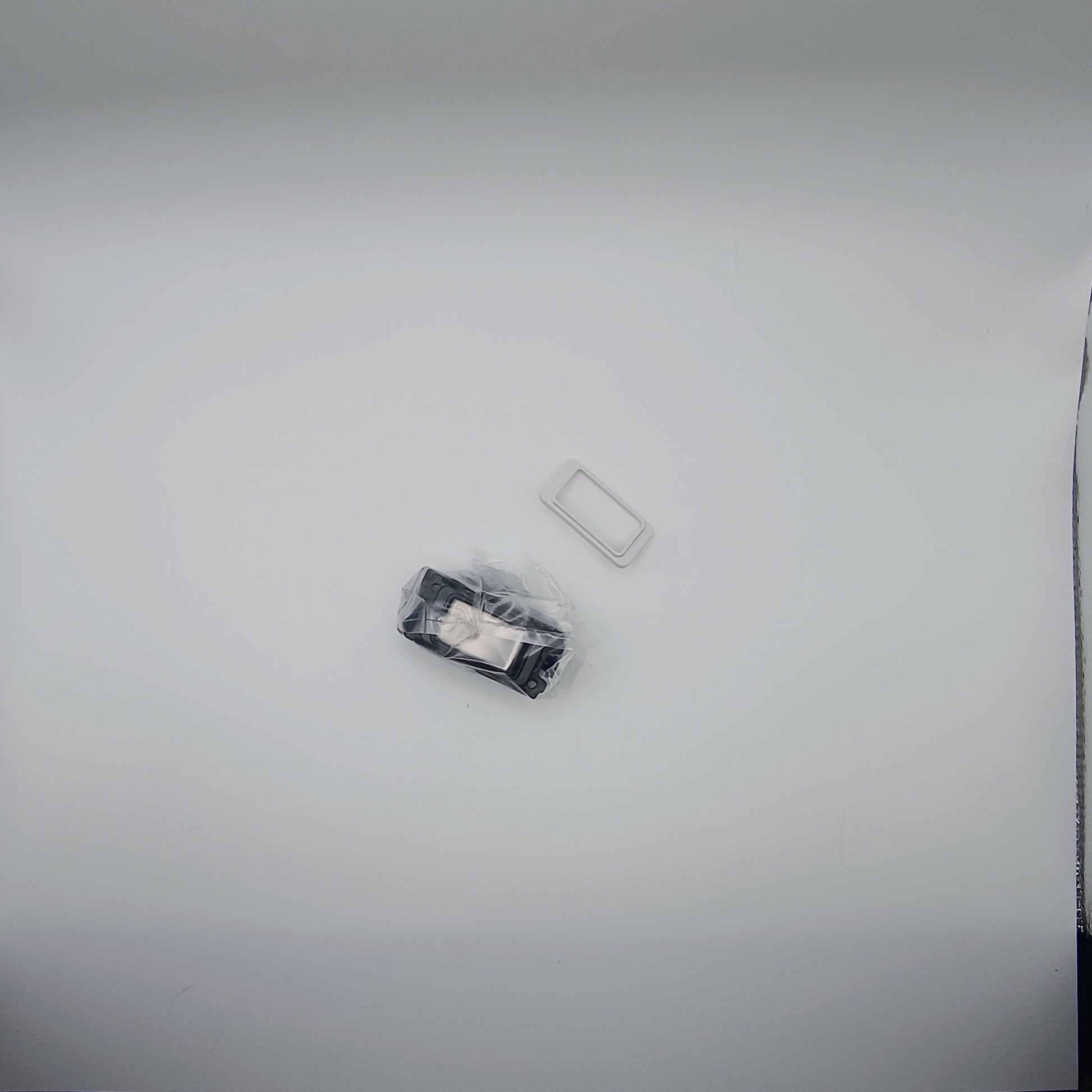 Two small rectangular objects on a light gray background