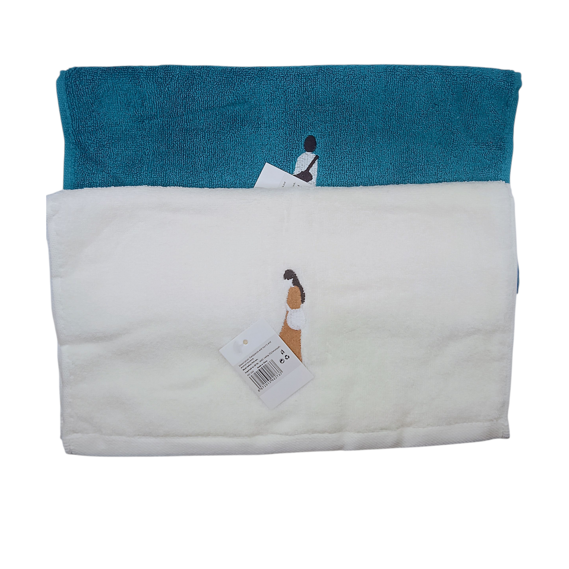 Folded towel with embroidered design on a white background