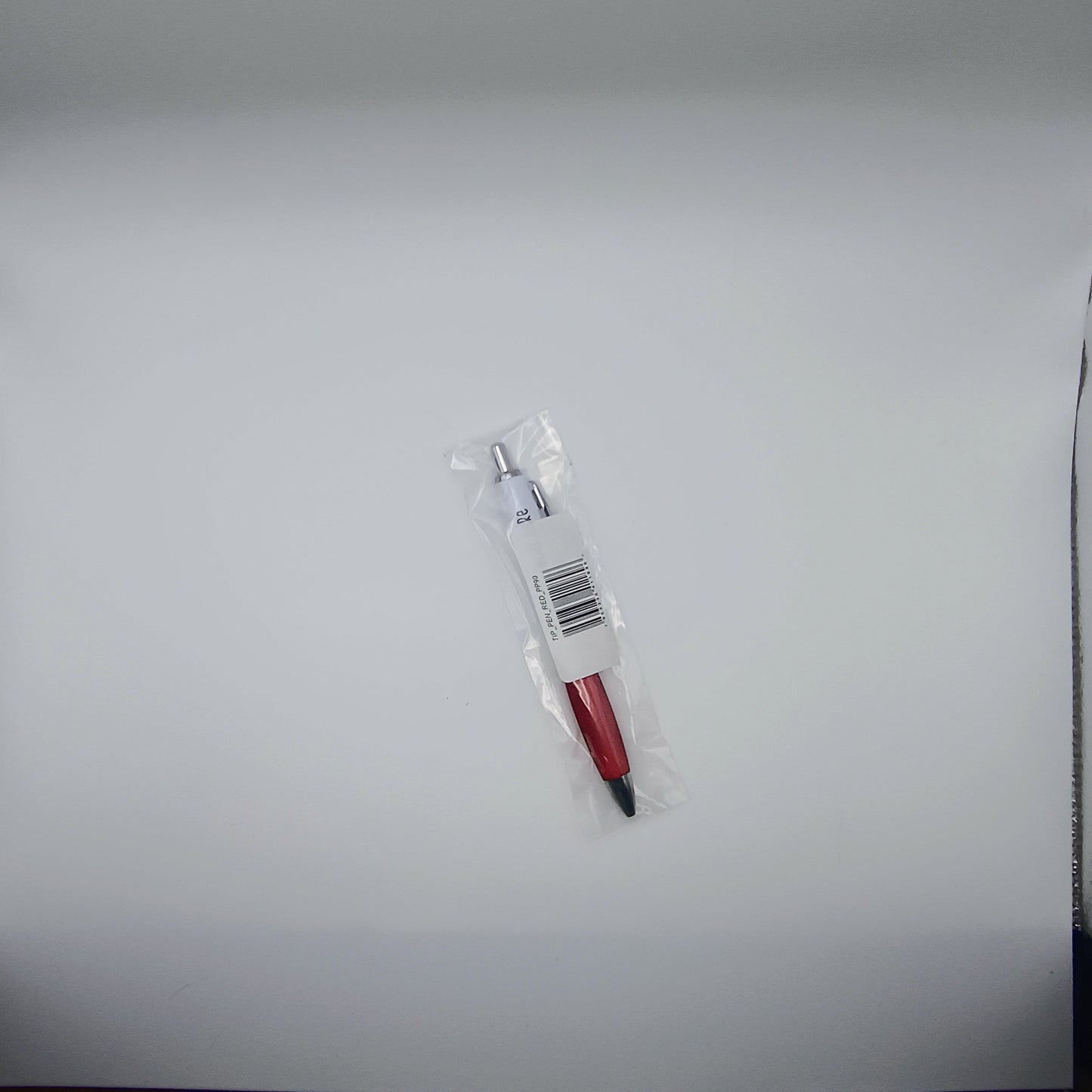 Pen with red accents and a clear plastic cover on a light gray background