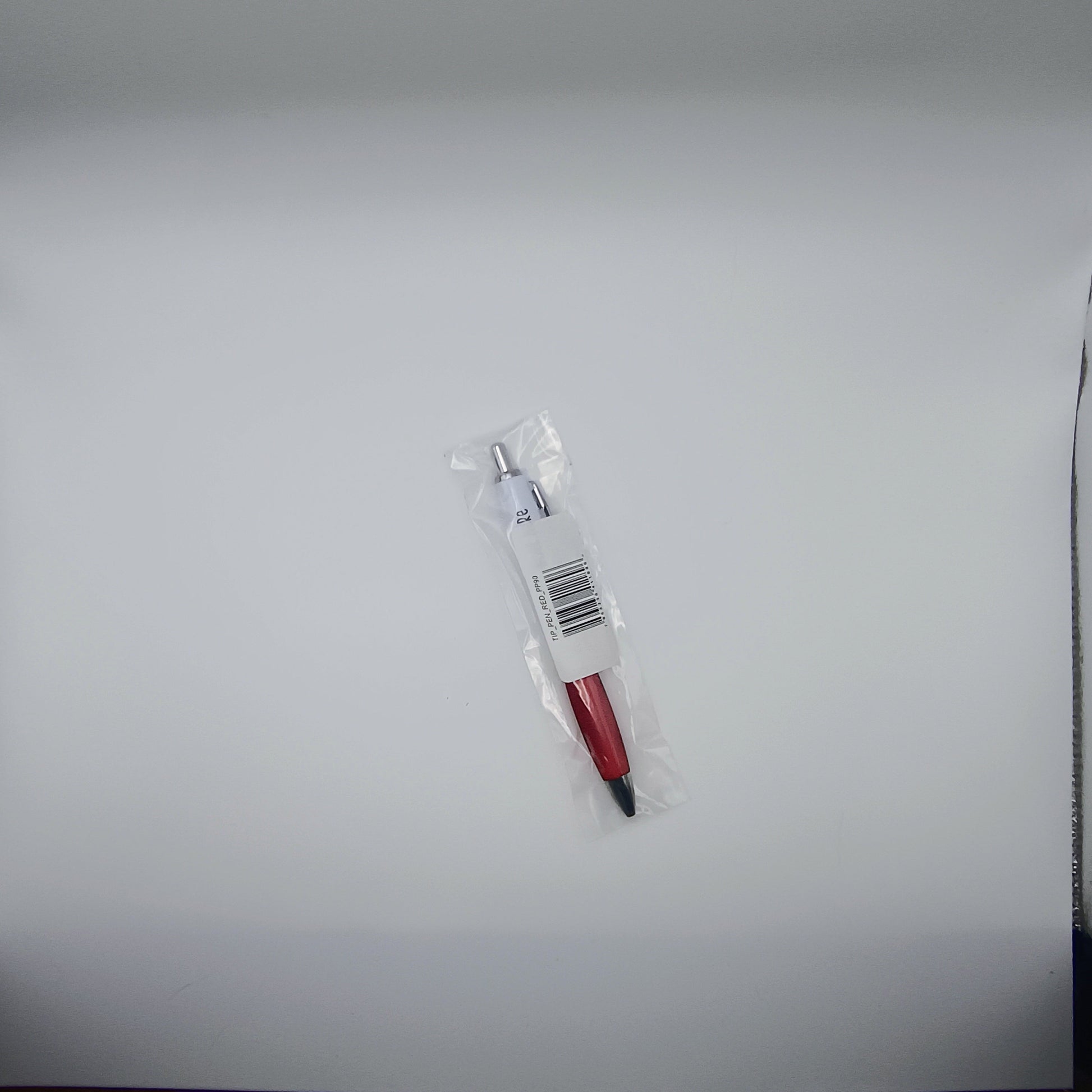 Pen with red accents and a clear plastic cover on a light gray background