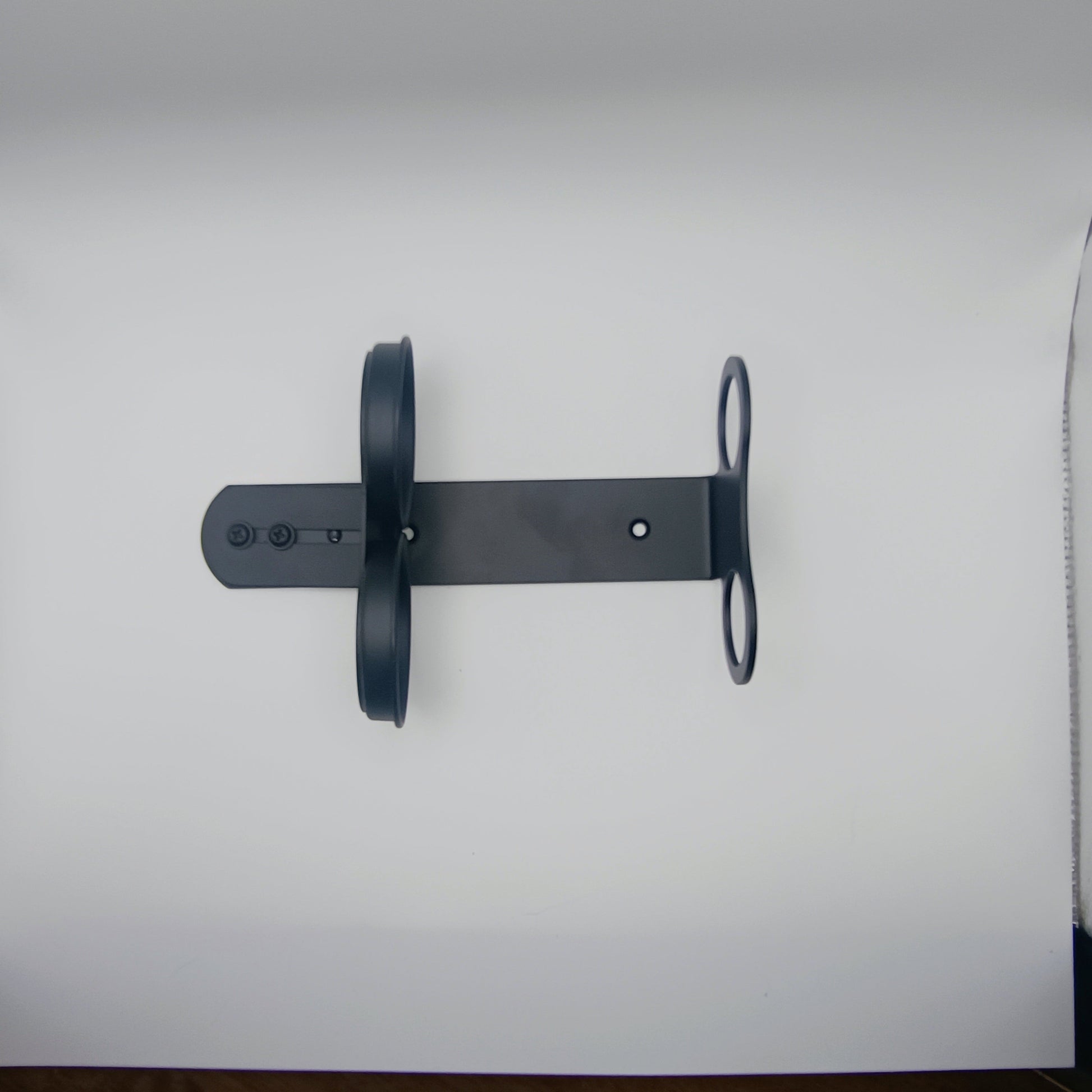 Black metal wall mount on a white background