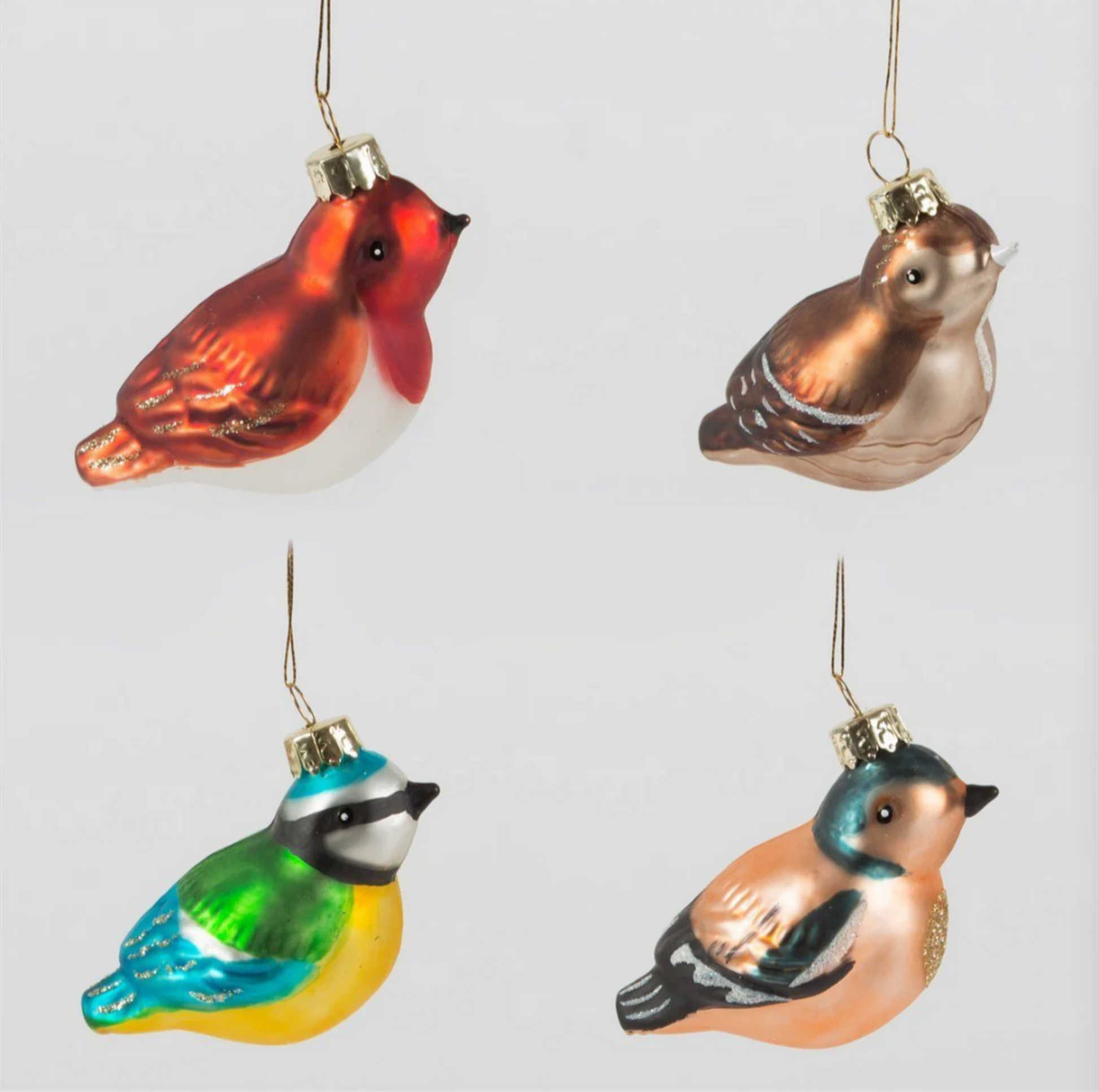 Four colorful bird-shaped Christmas ornaments on a light gray background