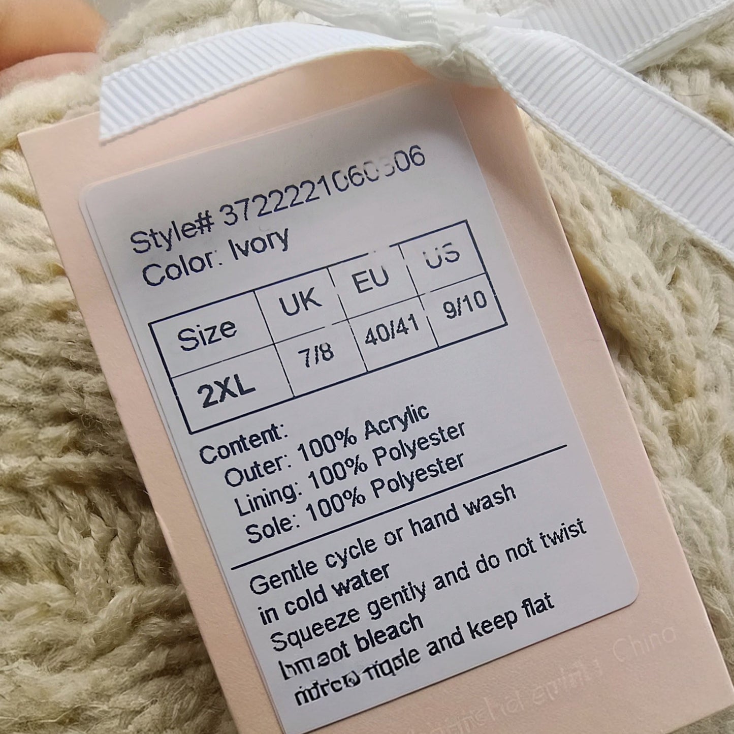 Product tag on a textured beige fabric background