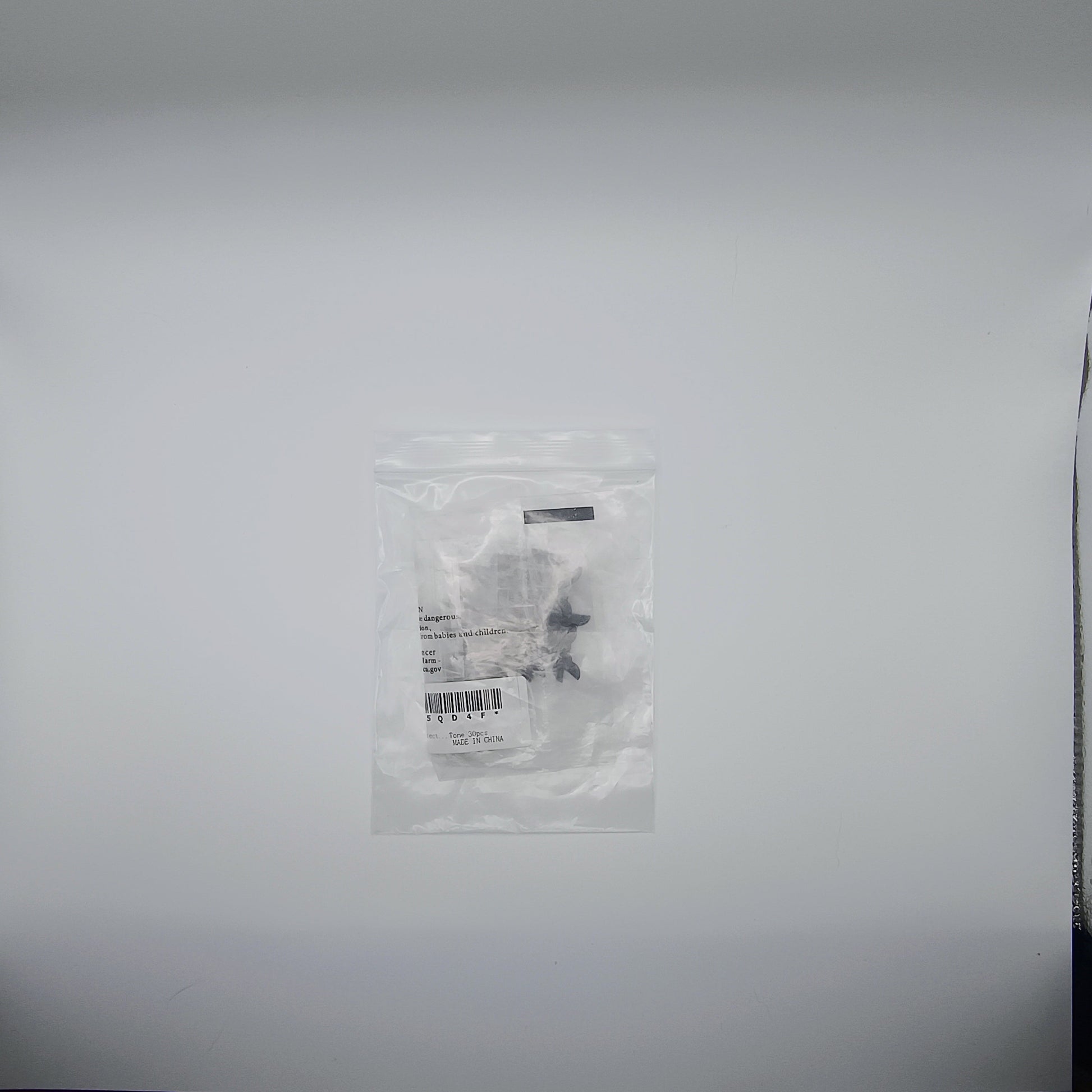 Small clear plastic bag with a label on a white background